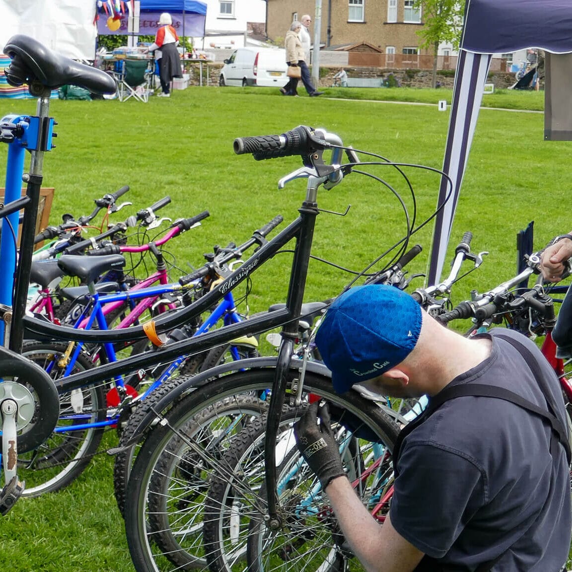 Two cyclist working on a bike